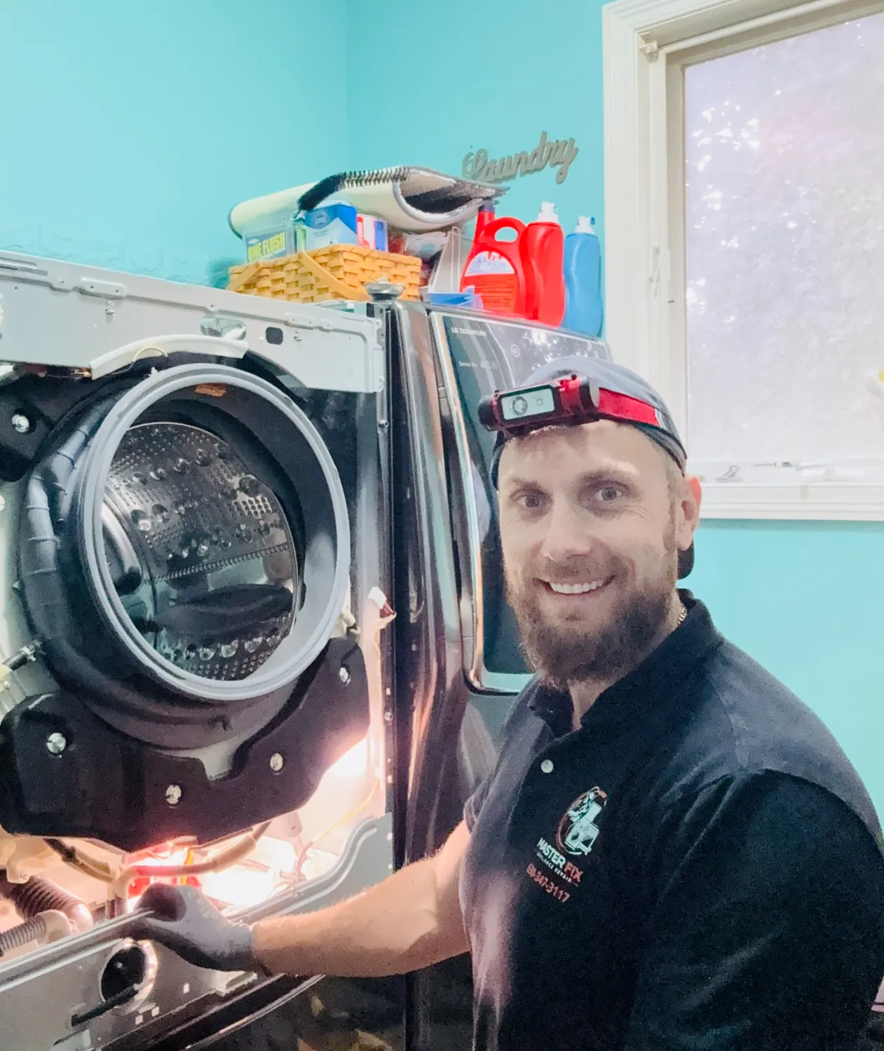 Technician servicing a washer
